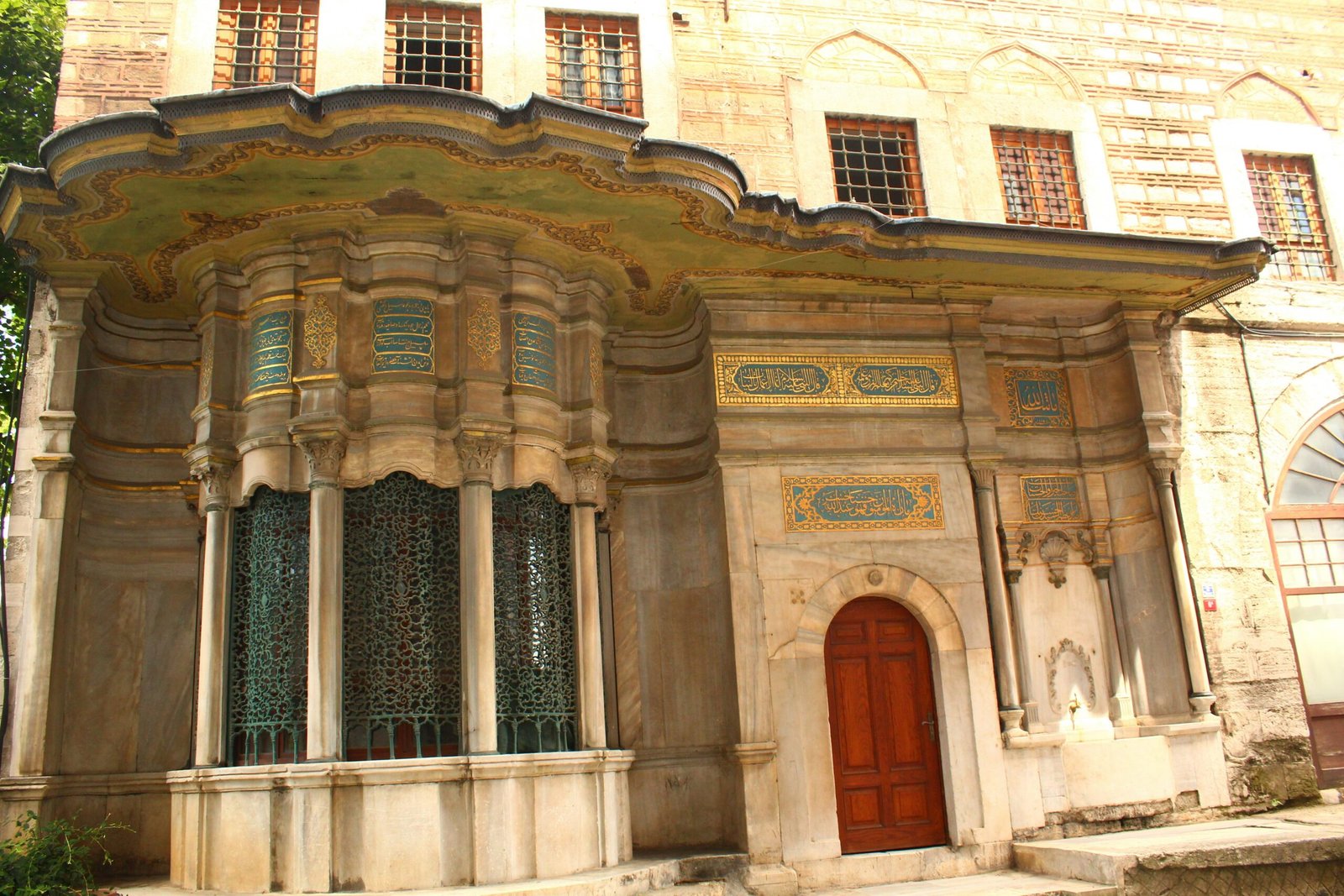 a large building with a red door and windows